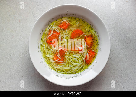 Chicken soup with carrot and dill, view from above Stock Photo
