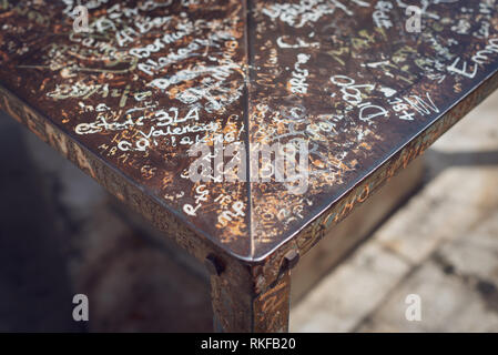 A metal seat covered in names and graffiti at the top of the El Miguelete, the bell tower of the Valencia Cathedral, in Valencia, Spain. Stock Photo