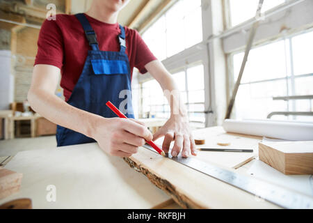 Making marks on wooden plank Stock Photo