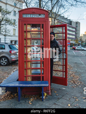 Berlin-Wilmersdorf. BucherboXX.Tiny lending library in Red Telephone box donated by British allies in front of Fehrbelliner Platz 4 Stock Photo