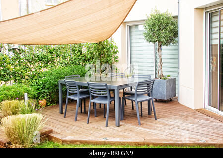 Modern terrace with dining table and chairs Stock Photo