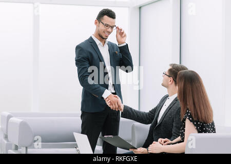 Manager shaking the hand of the Bank customer. Stock Photo