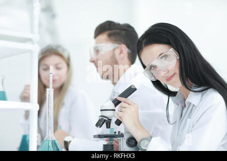 female scientist uses a microscope in the laboratory Stock Photo