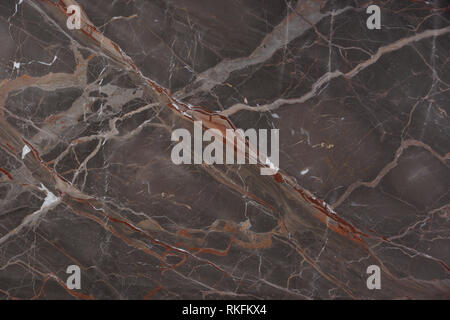 Beautiful brown marble with pink and red veins, called Caravaggio, natural stone, marble texture. Stock Photo