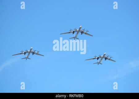 MOSCOW, RUSSIA - MAY 9, 2018: Three Russian military turboprop strategic bombers-missile Tu-95 Bear in flight in blue sky on parade on May 9, 2018 Stock Photo