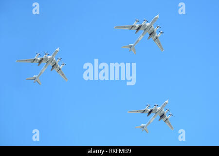 MOSCOW, RUSSIA - MAY 9, 2018: Three Russian military turboprop strategic bombers-missile Tu-95 Bear in flight in blue sky on parade on May 9, 2018 Stock Photo