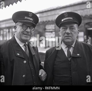 1968, two uniformed British Rail stationstaff, a foreman and ticket collector standing outside on a platform at Blackheath railway station, Blackheath, London, England, UK. Stock Photo