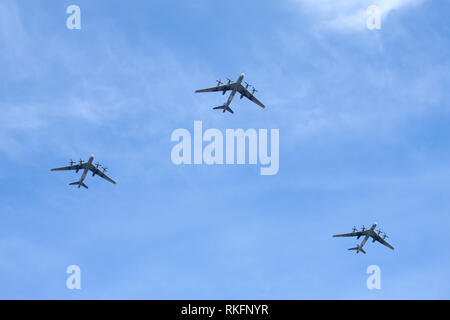 MOSCOW - MAY 9: Three Russian military turboprop strategic bombers-missile Tu-95 Bear in flight in blue sky on parade on May 9, 2015 Stock Photo