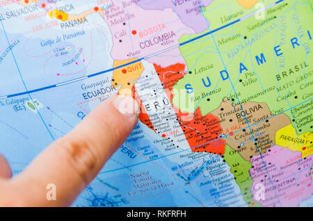 Finger of a man pointing to the next destination on a map, Travel Concept. Stock Photo