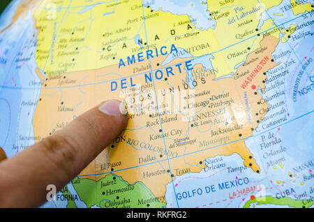 Finger of a man pointing to the next destination on a map, Travel Concept. Stock Photo