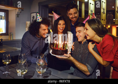 Group of friends celebrating a birthday at home Stock Photo - Alamy