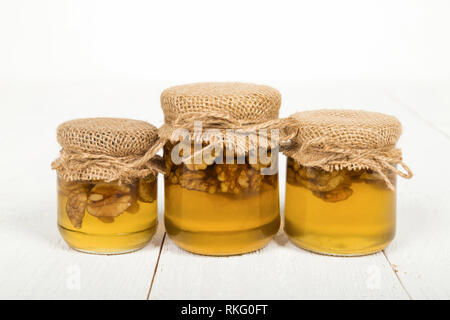 Nuts with honey in glass jars. Harvest of nuts. Delicacy and