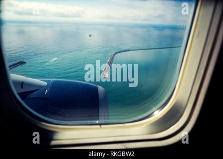 View from airplane window. View of containership leaving the port of Barcelona. Barcelona, Catalonia, Spain.