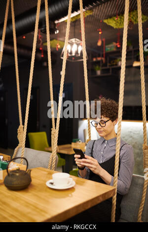 Texting in cafe Stock Photo
