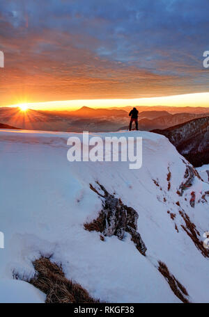 Man on Top with sun in background Stock Photo