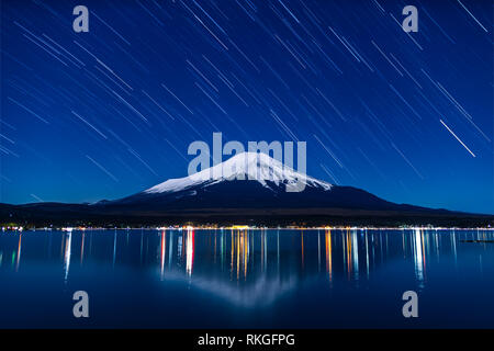 Nightview of Mount Fuji with startrails from Lake Yamanaka in winter. Stock Photo