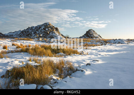 Waste granite piles at Foggintor Quarry in winter Dartmoor national park Devon Uk Stock Photo