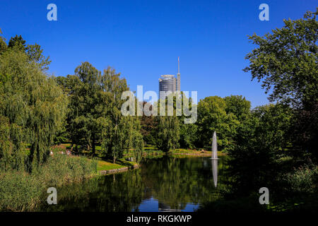 Essen, North Rhine-Westphalia, Ruhr area, Germany, Essen city garden, park landscape with lake and water fountain and RWE Tower on the occasion of the Stock Photo