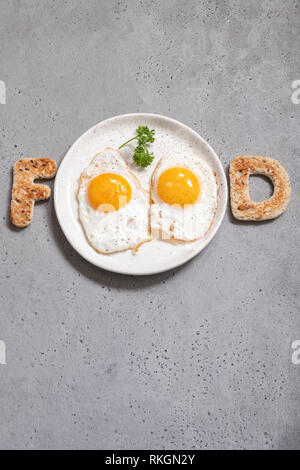 Word food written with toast letters eggs Stock Photo