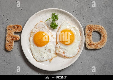 Word food written with toast letters eggs Stock Photo