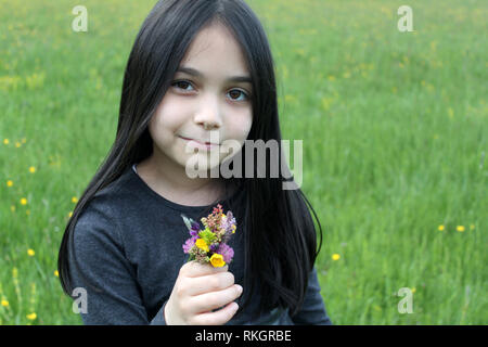 Beautiful little girl posing for session with flower bouquet Stock Photo