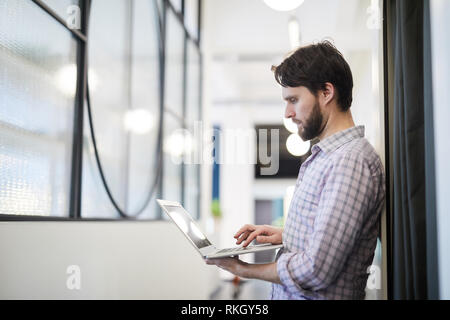 Man focused on online data Stock Photo