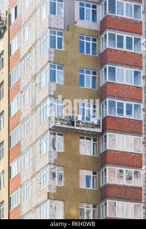Facade work and insulation of a multistory building Stock Photo