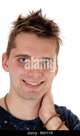 A close up image of a young man standing in a blue t-shirt with one hand on the back of his neck, isolated for white background Stock Photo