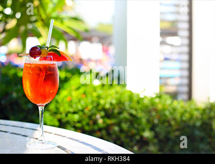 Glass of Aperol Spritz cocktail on the cafe table at the tropical resort Stock Photo