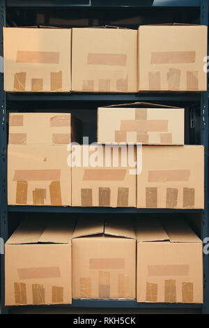 Cardboard boxes on shelves Stock Photo