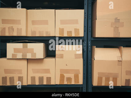 Cardboard boxes on shelves Stock Photo