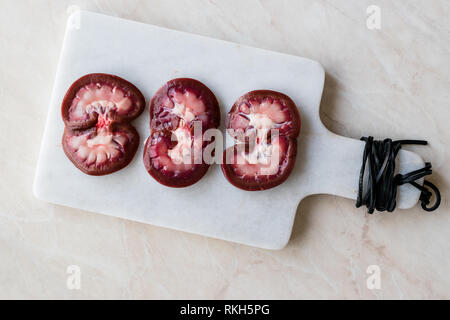 Sliced Raw Lamb Kidney on Marble Board. Organic Product. Stock Photo