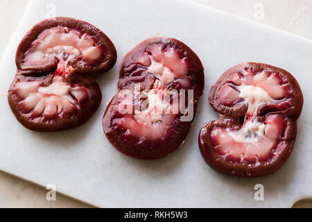 Sliced Raw Lamb Kidney on Marble Board. Organic Product. Stock Photo