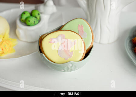 Easter spring decorative composition with homemade easter cookies in the shape of a funny rabbit, quail eggs Stock Photo