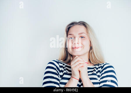 Portrait of beautiful smiling blonde woman in striped dress on white background with copy space. Young girl happy and very happy. Positive emotions, f Stock Photo