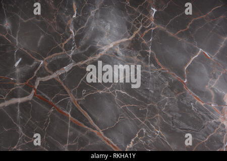 Brown marble with pink and red veins, called Caravaggio, natural stone, marble texture. Stock Photo