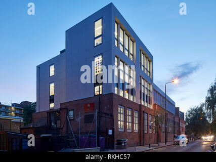 Street view showing additional floors at dusk. Gatehouse School, LONDON, United Kingdom. Architect: Child Graddon Lewis , 2018. Stock Photo