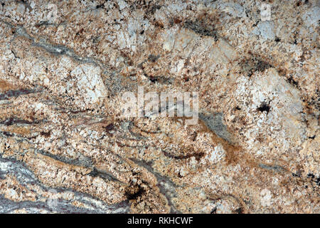 Natural beige granite with interesting patterns on the surface is called Golden cascade, stone texture, marble background. Stock Photo