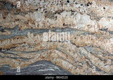 Beige granite with interesting patterns on the surface, called Golden cascade, stone texture, marble background Stock Photo