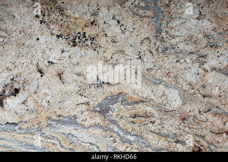 Beige granite with patterns on the surface, called Golden cascade, stone texture, marble background Stock Photo