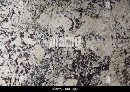 Beige granite with dark patterns on the surface, called Delicatus Cream. Stock Photo