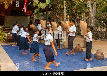 Cambodan school children wearing school uniform, perform traditional dance for tourists at Siem Reap, Cambodia, Asia Stock Photo