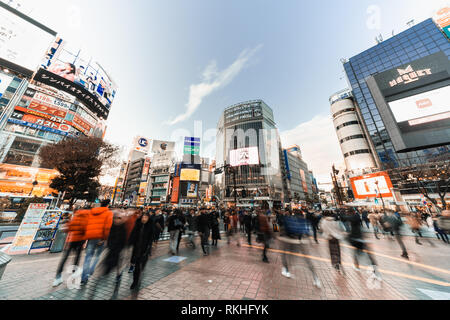 Tokyo, Japan - Jan 10, 2019: Motion blur of people walking at Shibuya crossing and car traffic transportation across intersection. Asia travel concept Stock Photo