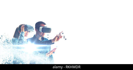 A man and a woman in glasses of virtual reality. The concept of modern technologies and technologies of the future. Fragmented by pixels. VR glasses. Stock Photo