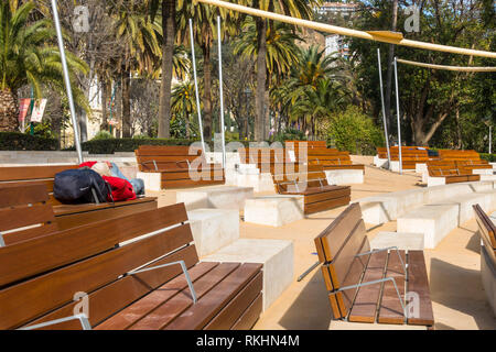 Homeless man sleeping on bench of outdoor theatre, Malaga, Andalusia, Spain. Stock Photo