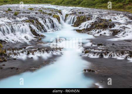 Detail of bright powerful Bruarfoss waterfall in Iceland with cyan water. Stock Photo