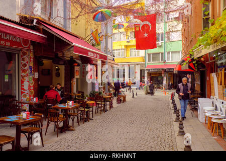 Local life on a Pedestrian street lined with business in the core of Kadikoy, on the asian side of Istanbul, Turkey - December Stock Photo