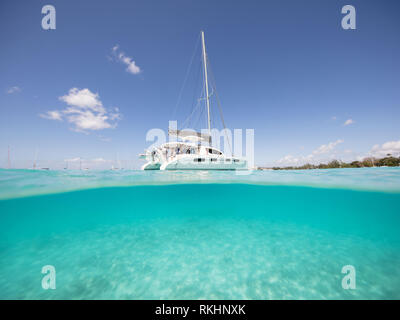 A beautuful under/over shot of a yacht moored in the stunning Carlisle Bay in Barbados Stock Photo