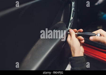 Mechanic installing car central door lock motor Stock Photo