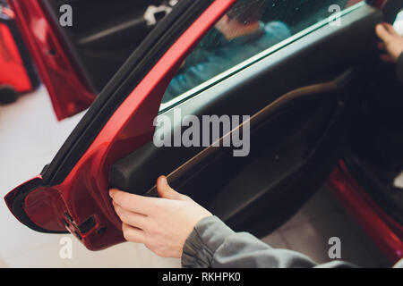 Mechanic installing car central door lock motor Stock Photo